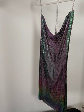 Metallic backless mini dress.  Side leg split.  Low cut front.  Spaghetti straps